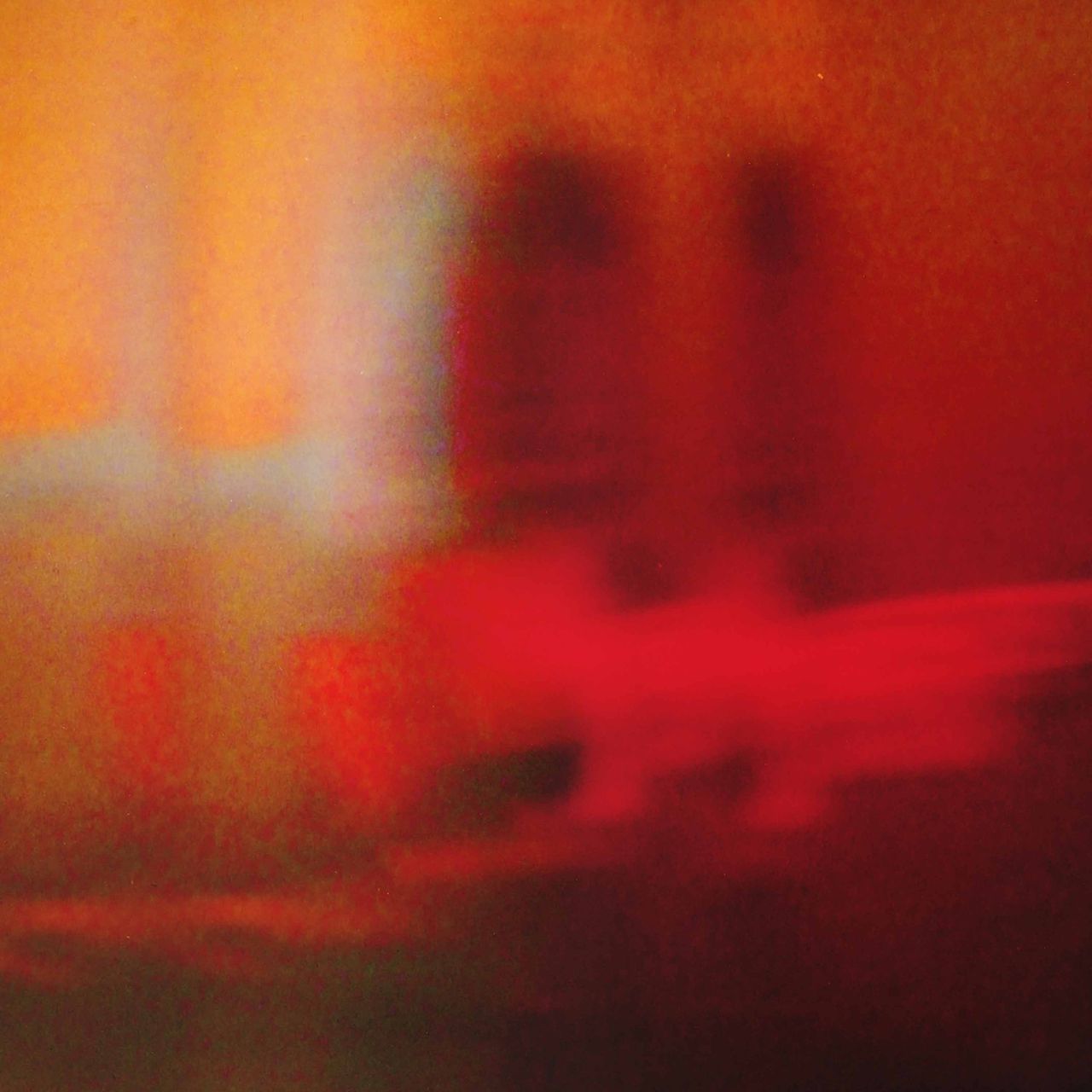 Single cover artwork for The Temper Trap's Slide featuring an abstract, motion-blurred warm red and yellow gradient.